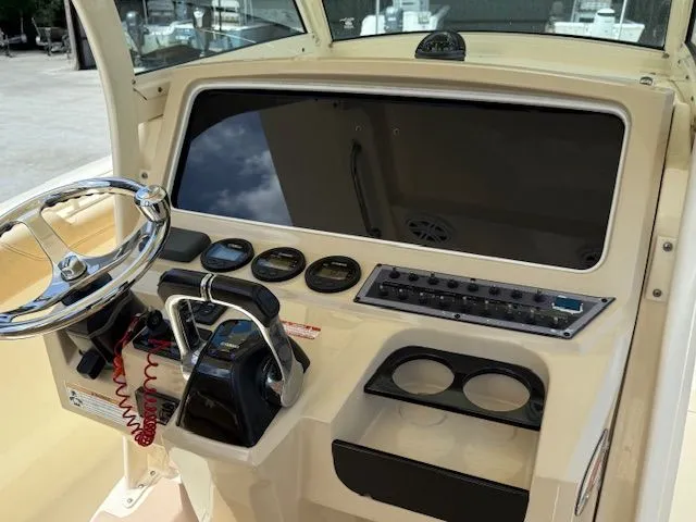 Slide: The Image of Dashboard of a 2017 Scout 275 LXF boat with steering and instruments. - 19