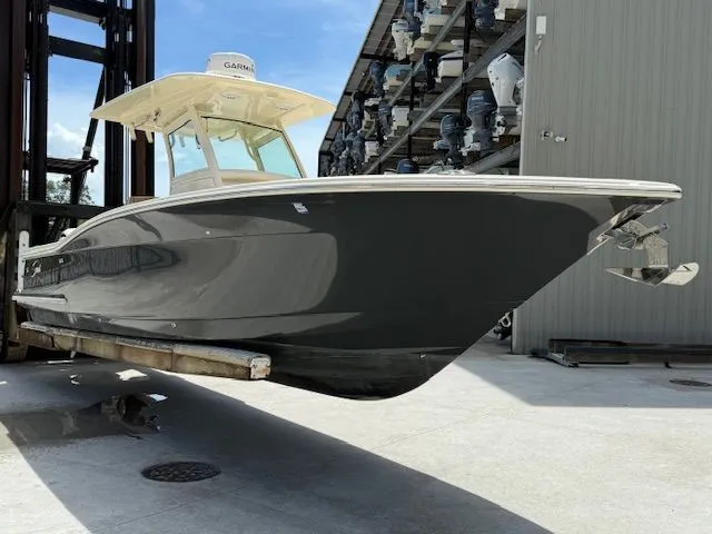 Slide: The Image of 2017 Scout 275 LXF boat on lift, side view. - 3