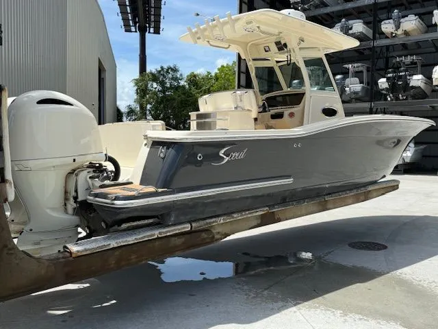Slide: The Image of 2017 Scout 275 LXF on an outdoor boat lift. - 4