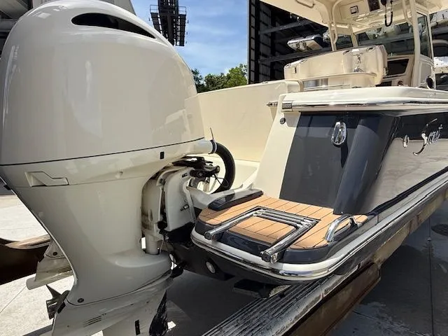 Slide: The Image of 2017 Scout 275 LXF with outboard motor and teak platform. - 5