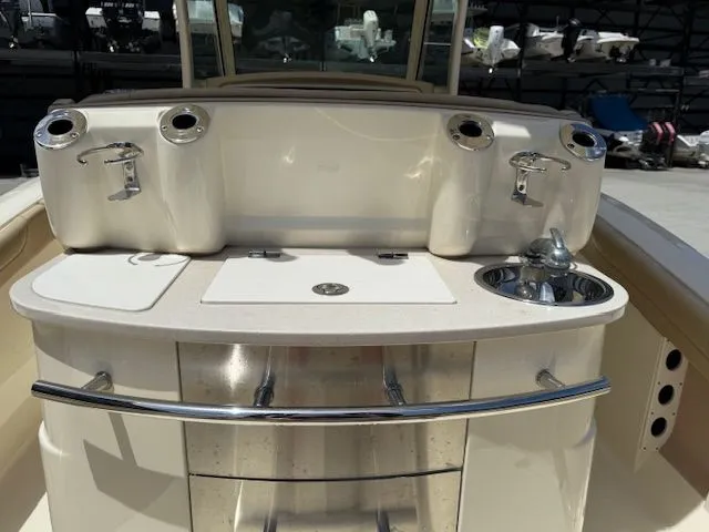 Slide: The Image of 2017 Scout 275 LXF boat kitchen with sink and storage. - 8