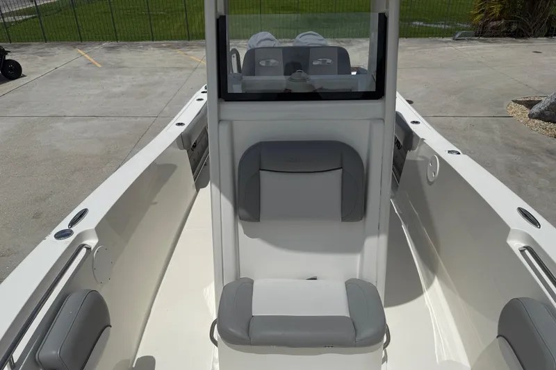 Slide: The Image of 2021 NauticStar 2602 Legacy boat interior with seating and console view. - 15