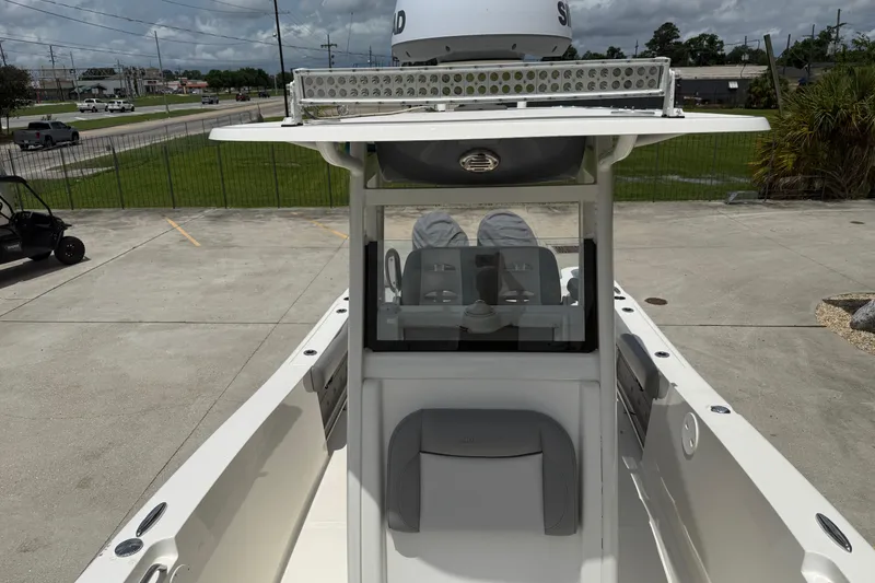 Slide: The Image of 2021 NauticStar 2602 Legacy boat, center console view, parked outdoors. - 16