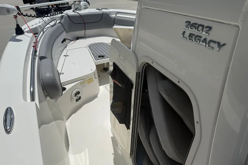 Slide: The Image of 2021 NauticStar 2602 Legacy boat interior with seating and storage compartment. - 17