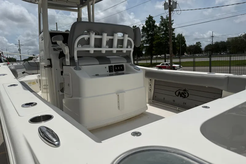 Slide: The Image of 2021 NauticStar 2602 Legacy boat interior with seating and fishing rod holders. - 7