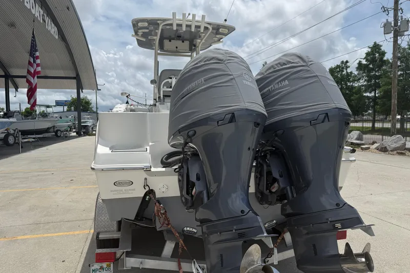 Slide: The Image of 2021 NauticStar 2602 Legacy boat with twin Yamaha engines at a boatyard. - 8