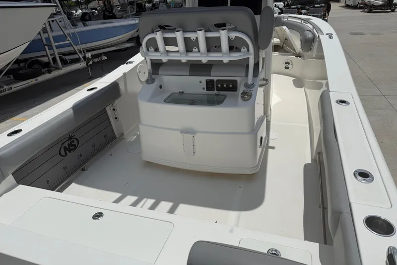 Slide: The Image of 2021 NauticStar 2602 Legacy boat interior with rod holders and seating. - 9
