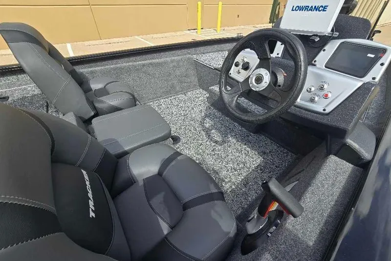 Slide: The Image of Interior of 2026 Tracker Pro Team 175 boat with steering wheel and control panel. - 2