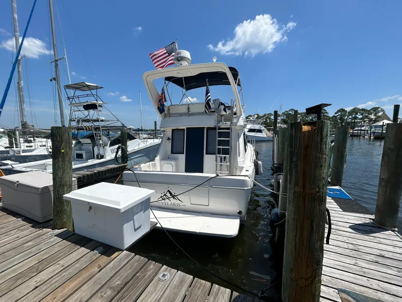 Slide: The Image of Bayliner 3788 Command Bridge Motoryacht 1997 docked at marina under clear blue sky. - 2
