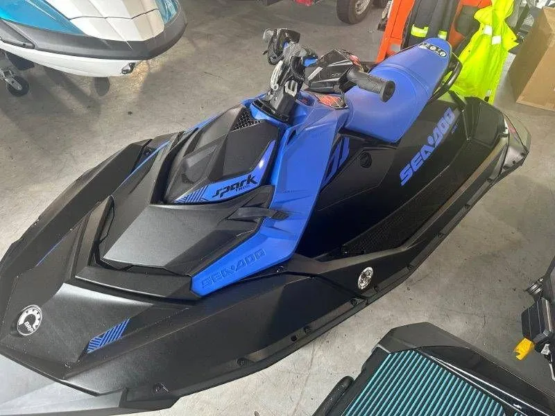 The Image of 2023 Sea-Doo SPARK 2up Trixx in blue and black in a garage. - 1