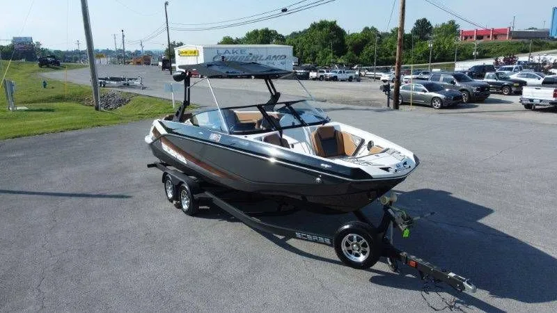 Slide: The Image of 2018 Scarab 255 ID Wake Ed boat on trailer outdoors. - 11
