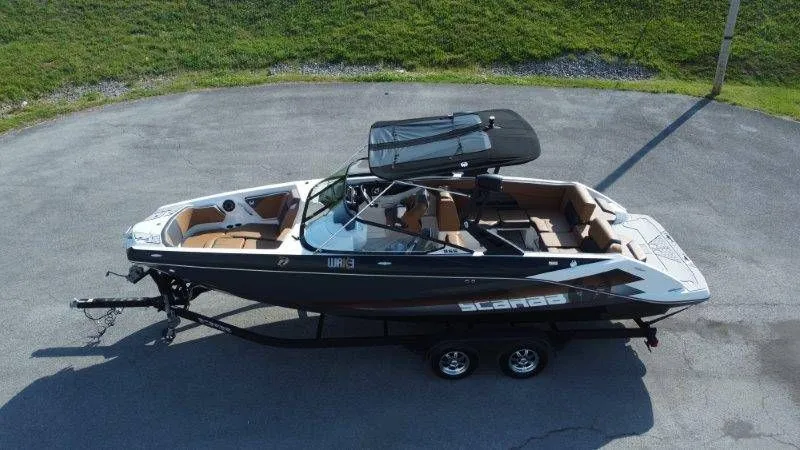 Slide: The Image of 2018 Scarab 255 ID Wake Ed boat on trailer, side view. - 13