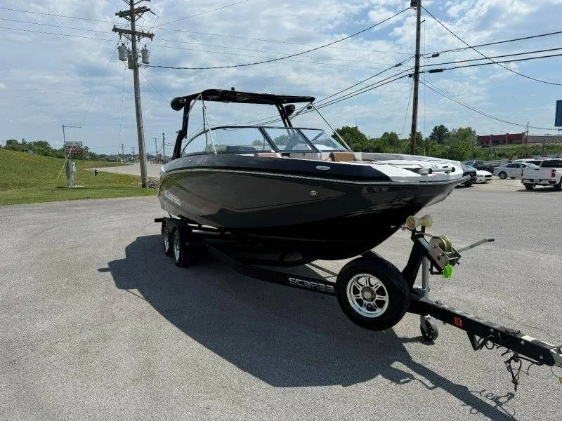 Slide: The Image of 2018 Scarab 255 ID Wake Ed boat on trailer outdoors. - 27