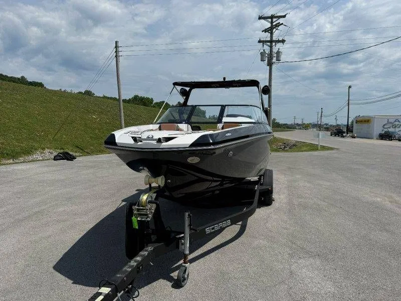 Slide: The Image of 2018 Scarab 255 ID Wake Ed boat on trailer, sunny day. - 28
