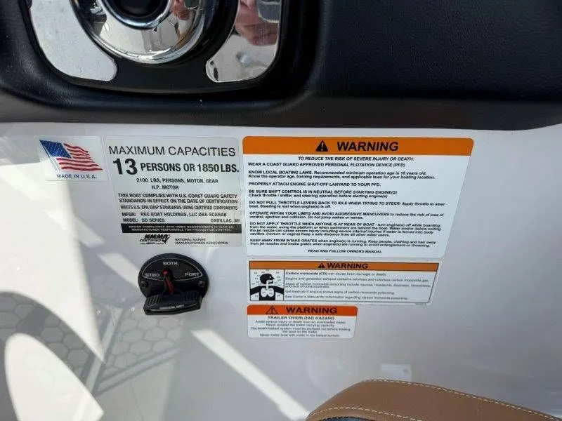 Slide: The Image of Safety and capacity labels on a 2018 Scarab 255 ID Wake Ed boat. - 44