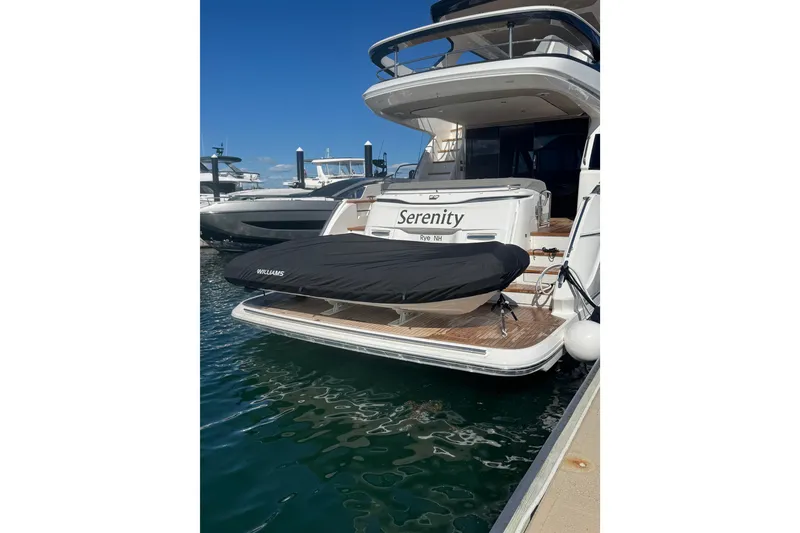 Slide: The Image of Luxury Princess F65 yacht "Serenity" docked, featuring a covered Williams tender. - 30