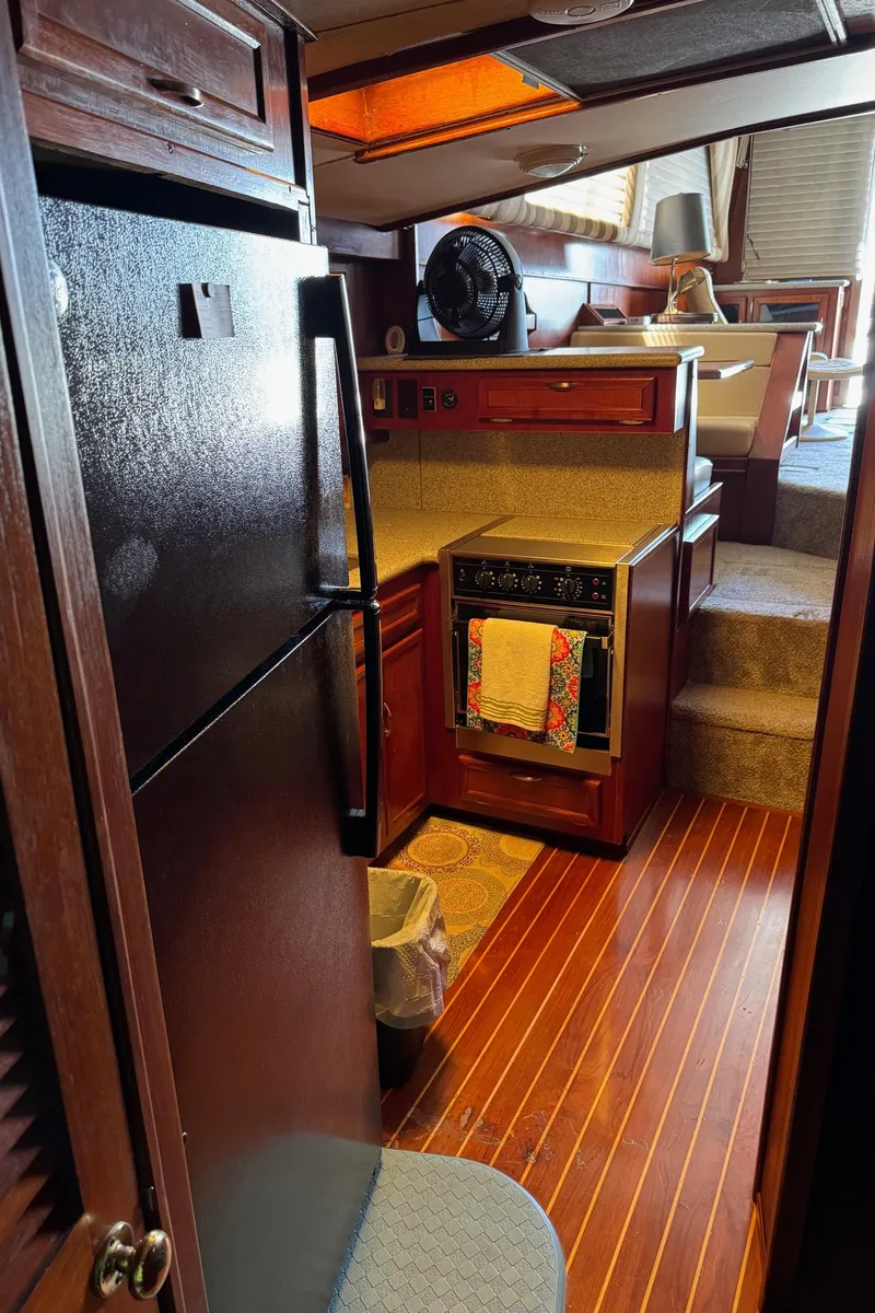 Slide: The Image of Interior of 1982 Viking 46 Convertible yacht with kitchen and wooden flooring. - 11