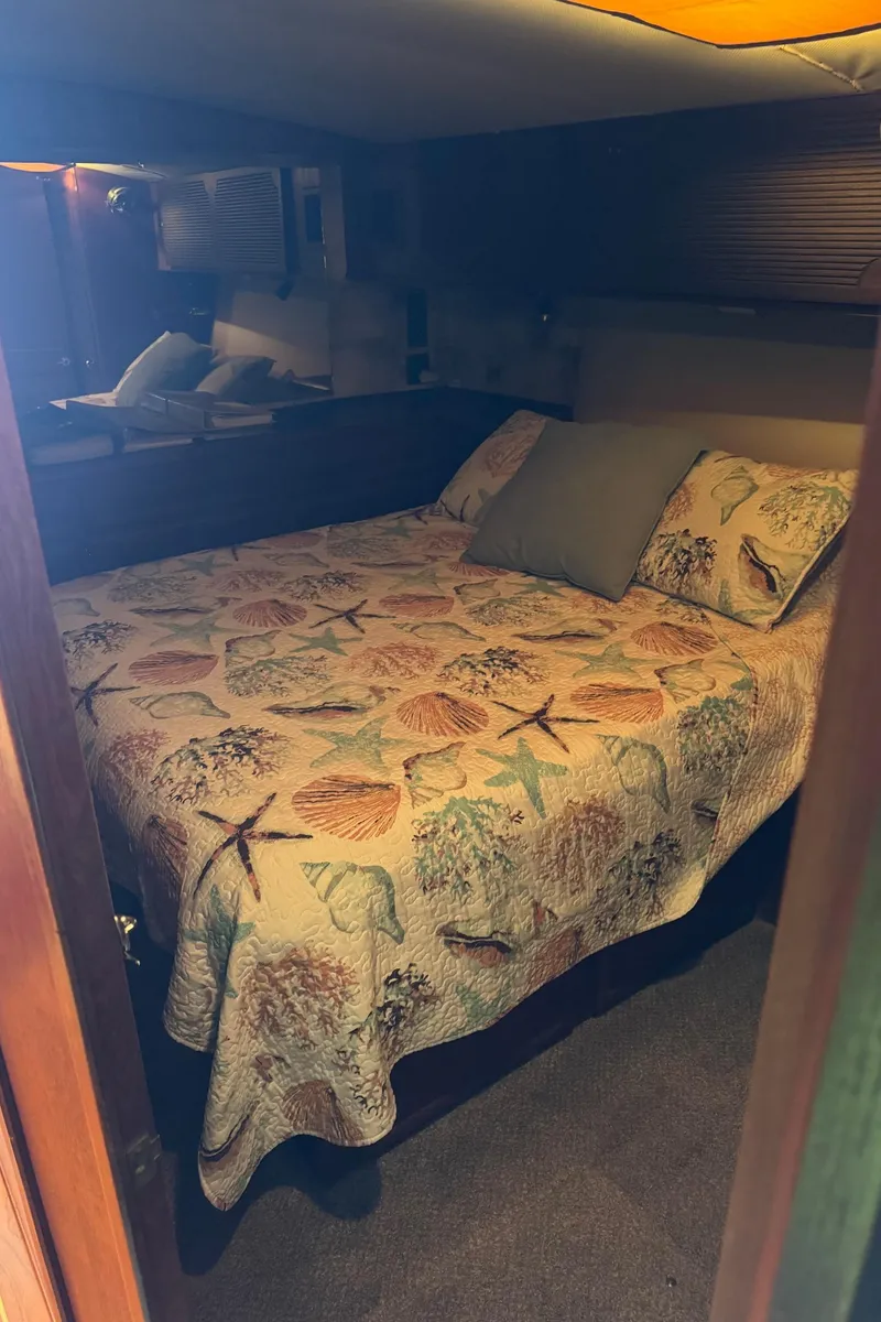 Slide: The Image of Cozy bedroom in 1982 Viking 46 Convertible boat with seashell-themed bedding. - 13