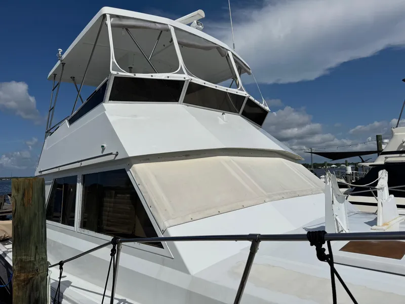 Slide: The Image of 1982 Viking 46 Convertible yacht docked under a clear blue sky. - 2