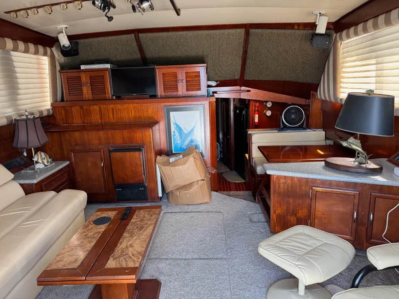 Slide: The Image of Interior of a 1982 Viking 46 Convertible yacht with wood furnishings and cozy seating. - 6