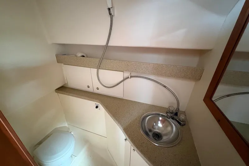 Slide: The Image of Compact bathroom in 2004 Luhrs 30 Open boat with sink and toilet. - 12