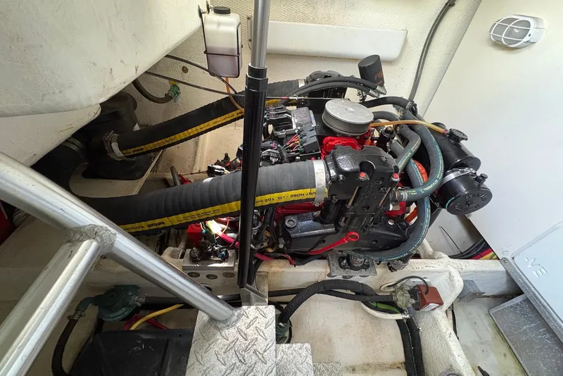 Slide: The Image of Engine compartment of a 2004 Luhrs 30 Open boat, showcasing mechanical components. - 13