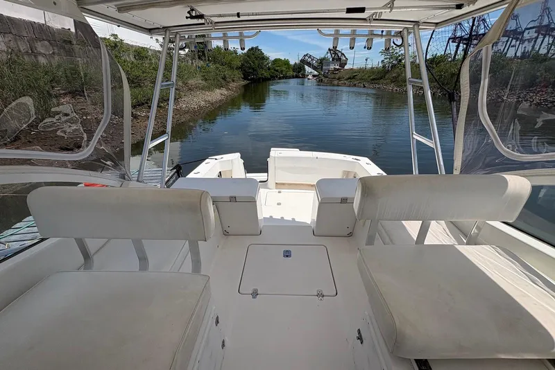 Slide: The Image of 2004 Luhrs 30 Open boat interior with seating, overlooking a calm waterway. - 7