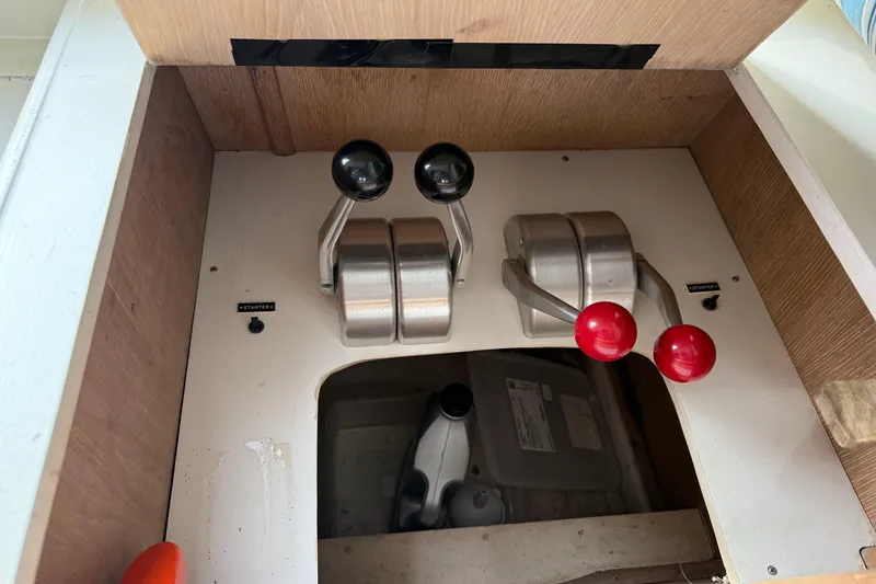 Slide: The Image of Control panel of a 1991 Californian 55 Cockpit Motor Yacht with throttle levers. - 19