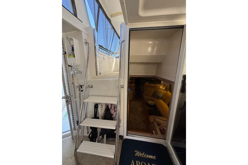 Slide: The Image of Interior view of 1991 Californian 55 Cockpit Motor Yacht with stairs and cozy seating area. - 20