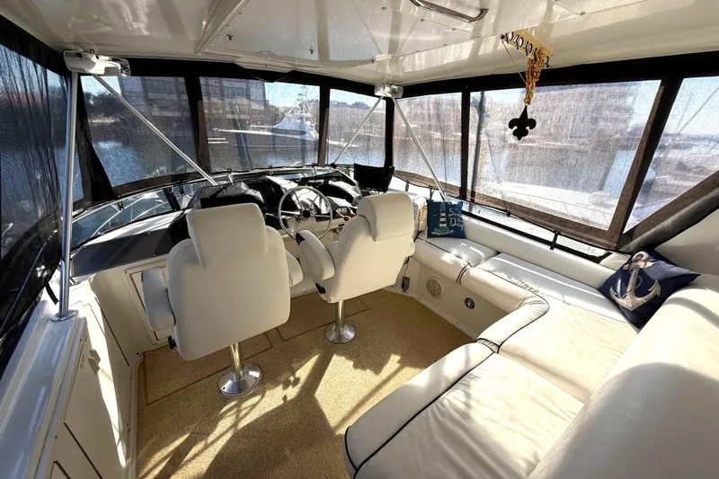 Slide: The Image of Luxurious 1991 Californian 55 Cockpit Motor Yacht interior with plush seating and helm. - 21