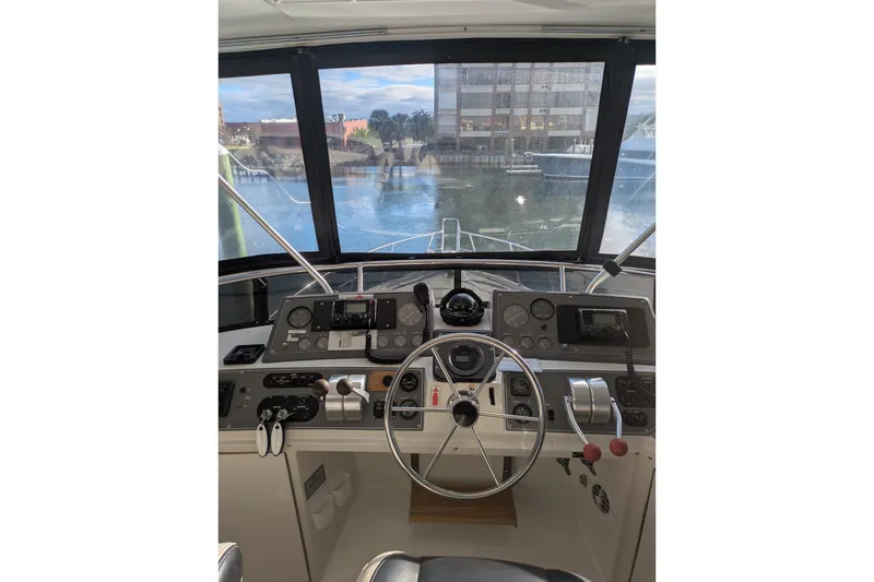 Slide: The Image of Cockpit view of 1991 Californian 55 Cockpit Motor Yacht with steering wheel and controls. - 22
