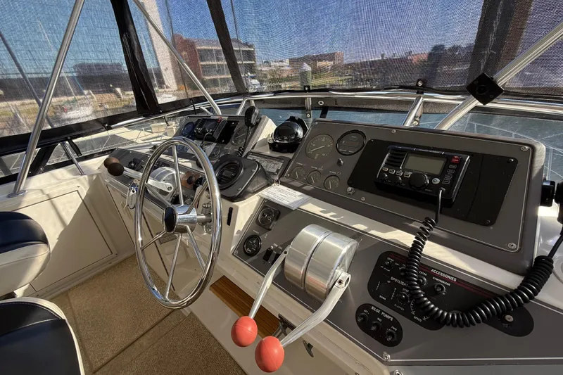 Slide: The Image of Cockpit of 1991 Californian 55 Cockpit Motor Yacht with steering wheel and control panel. - 24