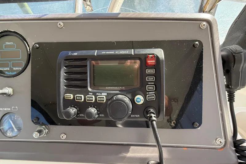 Slide: The Image of 1991 Californian 55 Cockpit Motor Yacht dashboard with marine radio and gauges. - 25