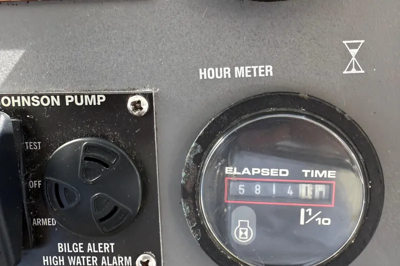 Slide: The Image of Hour meter and Johnson pump controls on 1991 Californian 55 Cockpit Motor Yacht. - 30