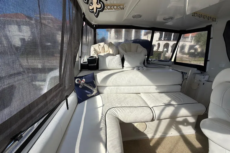 Slide: The Image of Interior of 1991 Californian 55 Cockpit Motor Yacht with white seating and nautical decor. - 31