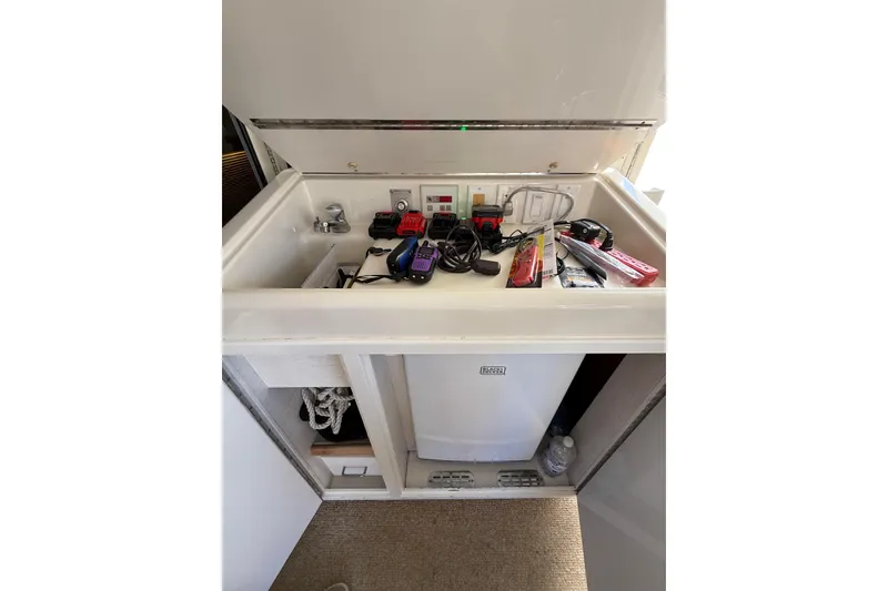 Slide: The Image of 1991 Californian 55 Cockpit Motor Yacht interior storage with electronics and accessories. - 35