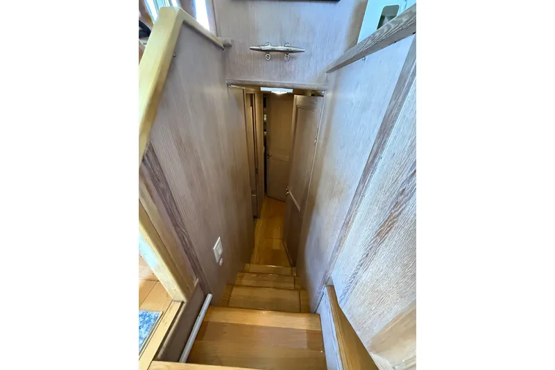 Slide: The Image of Staircase inside 1991 Californian 55 Cockpit Motor Yacht, featuring wooden steps and walls. - 44