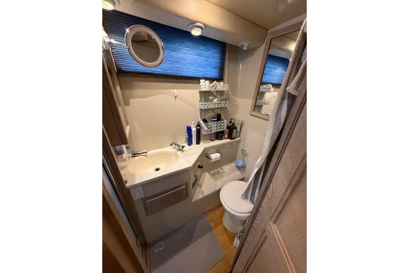 Slide: The Image of Bathroom interior of 1991 Californian 55 Cockpit Motor Yacht, featuring sink and toilet. - 45