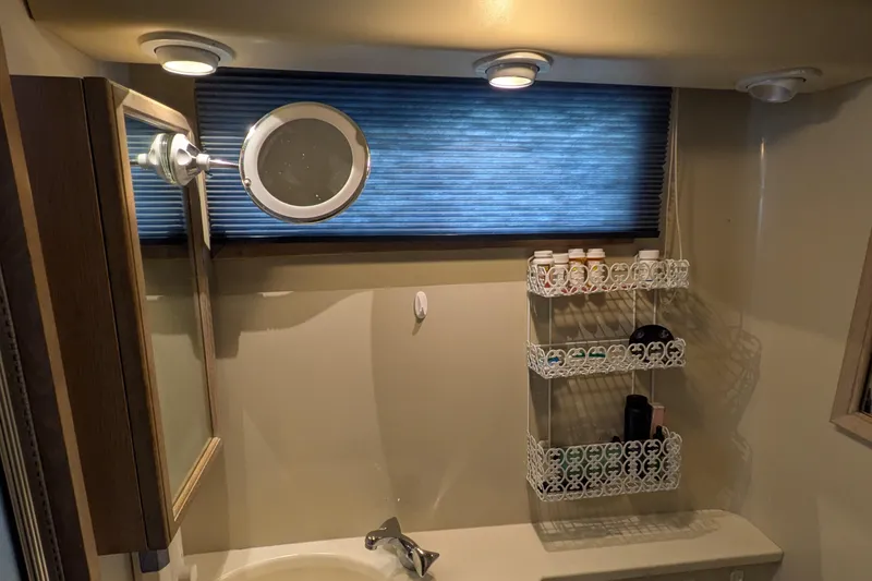 Slide: The Image of Bathroom interior of 1991 Californian 55 Cockpit Motor Yacht with mirror and shelf. - 46