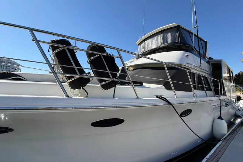 Slide: The Image of 1991 Californian 55 Cockpit Motor Yacht docked under clear blue sky. - 5