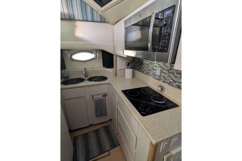 Slide: The Image of 1991 Californian 55 Cockpit Motor Yacht kitchen with modern appliances and sleek countertops. - 57