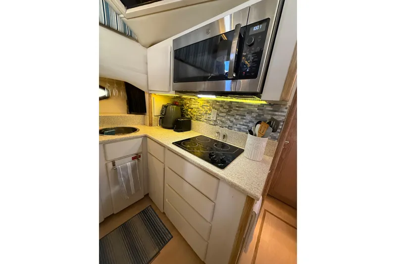 Slide: The Image of Modern kitchen in 1991 Californian 55 Cockpit Motor Yacht with microwave and stovetop. - 58