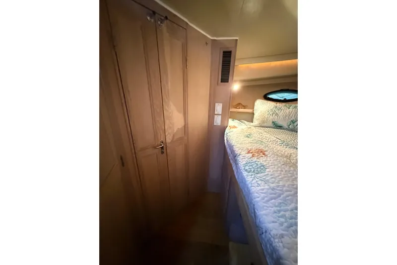 Slide: The Image of Interior cabin of 1991 Californian 55 Cockpit Motor Yacht with cozy bed and wooden closet. - 67