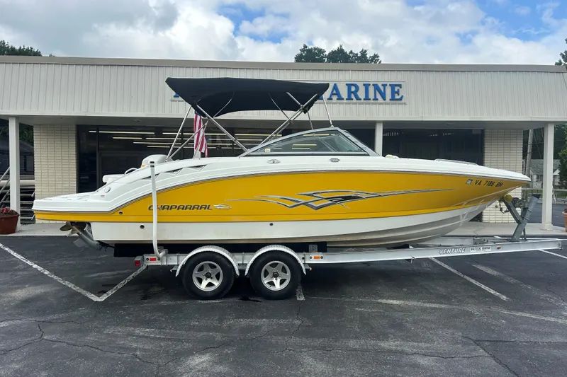 The Image of 2008 Chaparral Sunesta 244 boat on trailer, parked outside a marine dealership. - 0