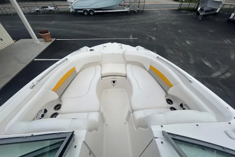 Slide: The Image of 2008 Chaparral Sunesta 244 boat interior with white seating and yellow accents. - 10