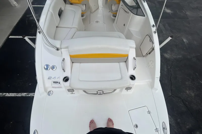 Slide: The Image of 2008 Chaparral Sunesta 244 boat interior with white and yellow seating, viewed from above. - 12