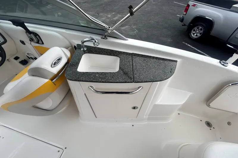 Slide: The Image of 2008 Chaparral Sunesta 244 boat interior with sink and seating area. - 15