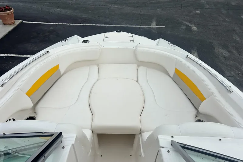 Slide: The Image of 2008 Chaparral Sunesta 244 boat interior with white seating and yellow accents. - 19