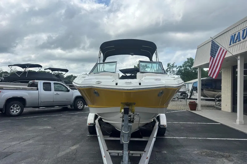 Slide: The Image of 2008 Chaparral Sunesta 244 boat on trailer at dealership, overcast sky. - 2