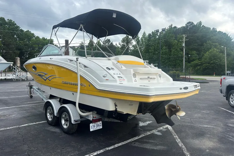 Slide: The Image of 2008 Chaparral Sunesta 244 boat with yellow accents on a trailer in a parking lot. - 4